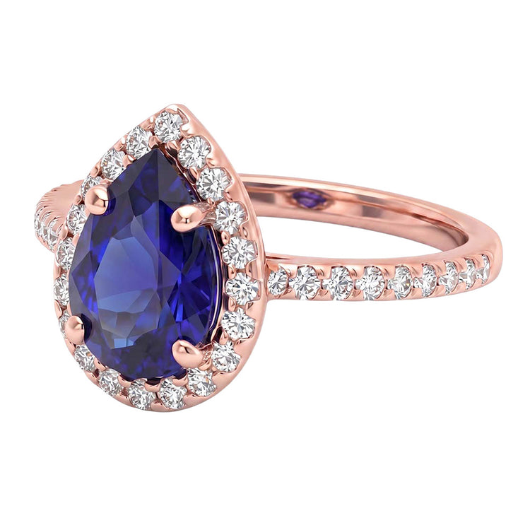Bague en or rose avec halo et saphir bleu taille poire et diamants 3 carats