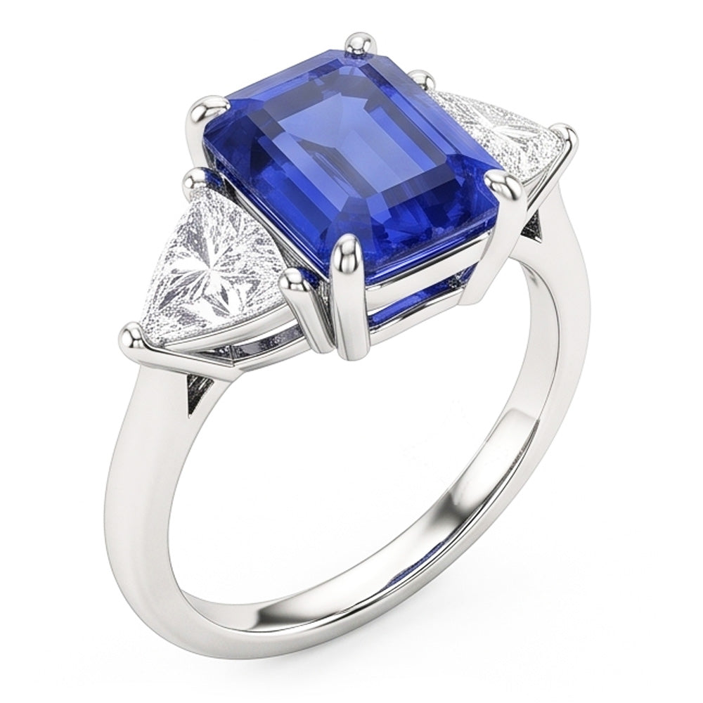 Bague trois pierres saphir bleu. émeraude et trillion de diamants 2.50 carats