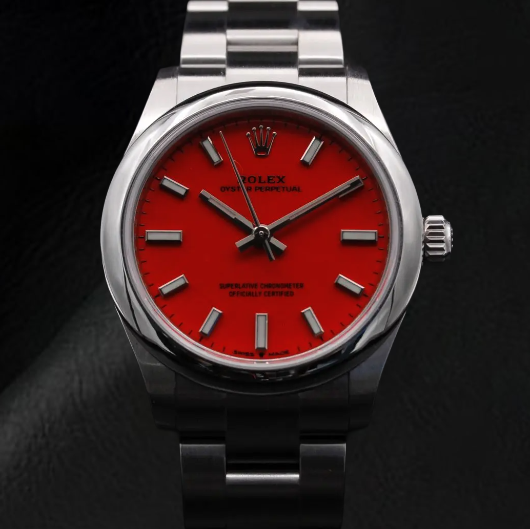 Montre Rolex dame huître Perpétuelle 31 mm en acier à cadran lumineux rouge corail