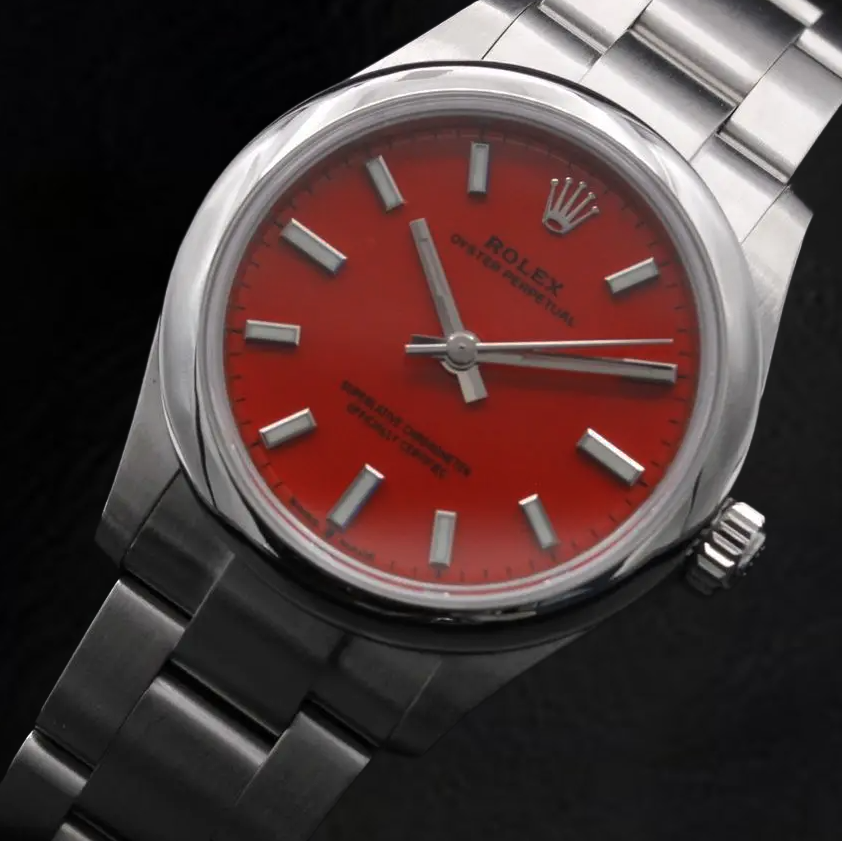 Montre Rolex dame huître Perpétuelle 31 mm en acier à cadran lumineux rouge corail