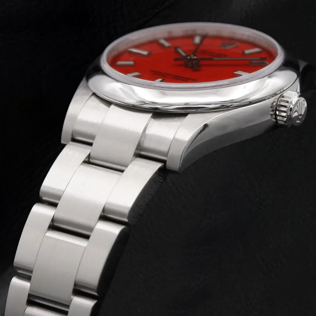 Montre Rolex dame huître Perpétuelle 31 mm en acier à cadran lumineux rouge corail