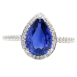 Bague de fiançailles en or et diamants sertis halo et saphir bleu 4 carats