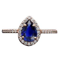 Bague en or rose avec halo et saphir bleu taille poire et diamants 3 carats